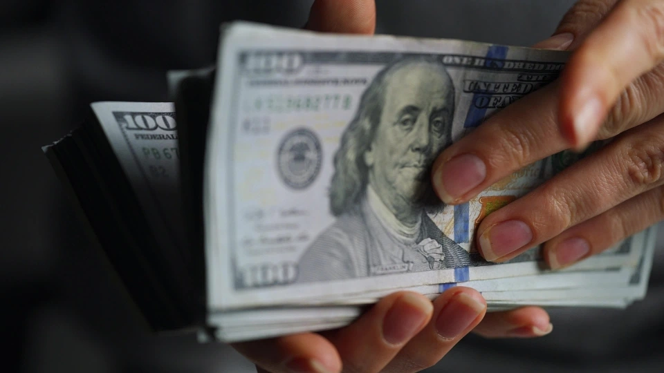 hands-checks-us-dollar-bills-or-counting-in-cash-against-the-backdrop-of-police-car-lights-video.jpg