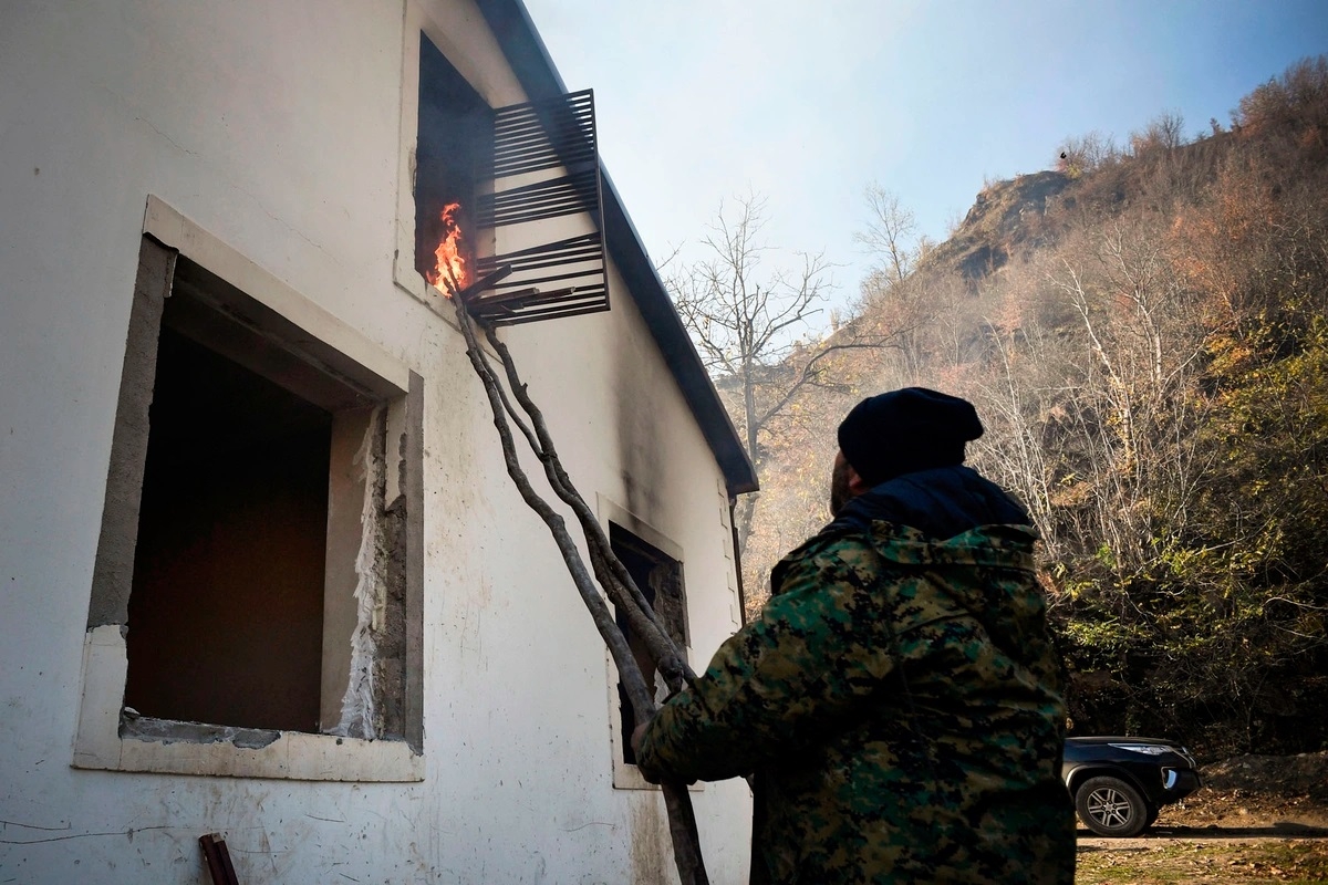 Một cư dân Armenia phóng hỏa đốt nhà mình ở ngôi làng Charektar (ngoại ô Kalbajar) trước khi di tản sang Armenia trước thời hạn bàn giao lãnh thổ này cho phía Azerbaijan. Ảnh: AFP.