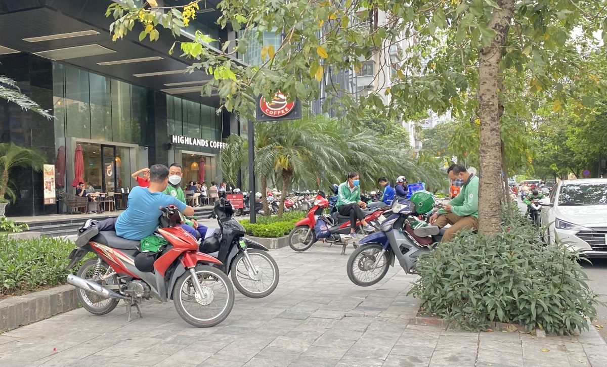 Nhóm tài xế lác đác trên vỉa hè “than thở” vì giá xăng tăng cao.