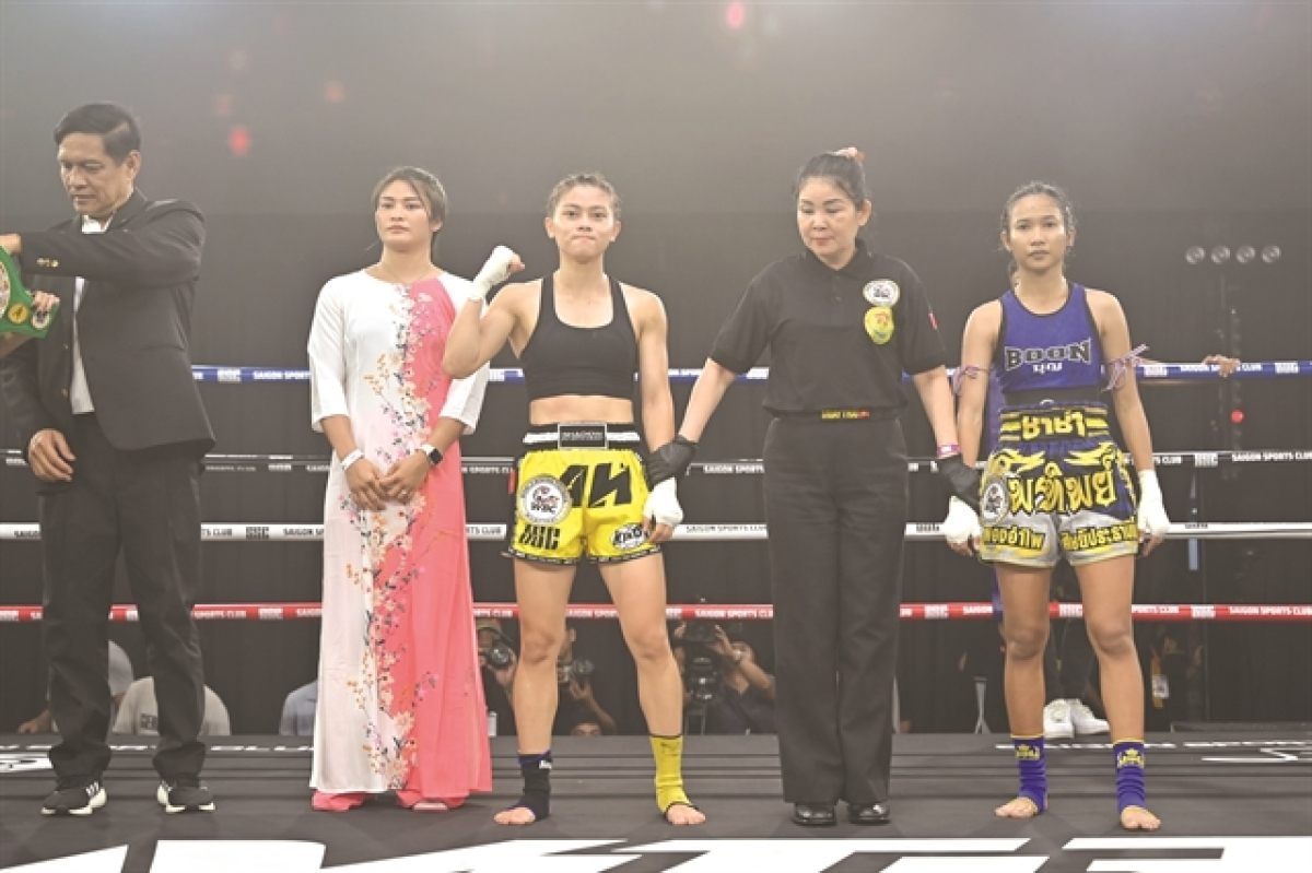 Huynh Ha Huu Hieu (third left) celebrates beating Pornthip Khamthongphanow of Thailand to win the WBC Muay Thai International Title in the women's minimumweight class. — Photo courtesy of Shadow Entertainment