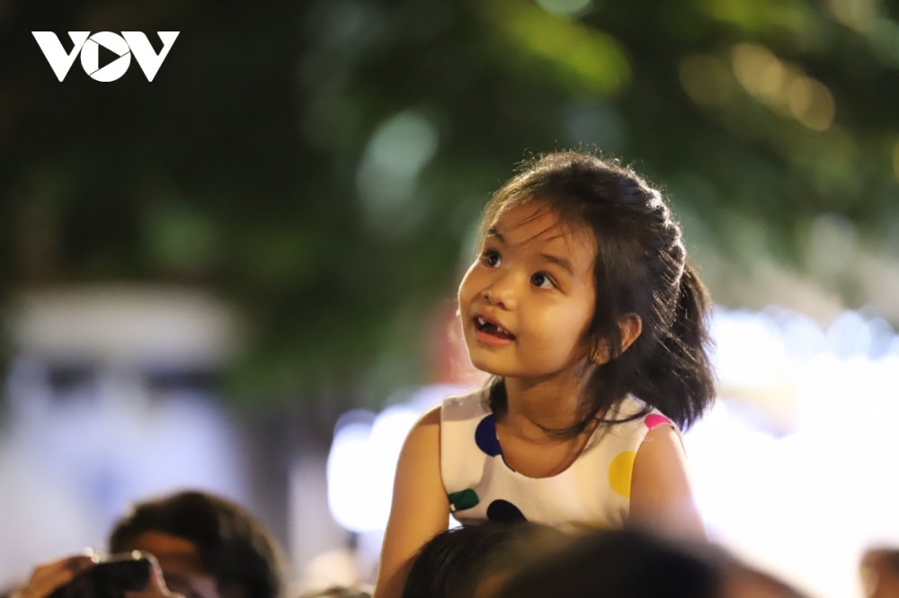 Many children are excited to watch the spectacular fireworks display in the skies.