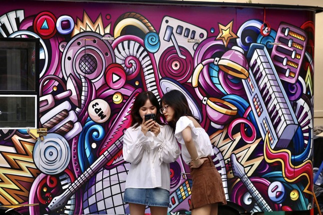 Many young people prefer taking a photo with a colourful, eye-catching designs in the background.