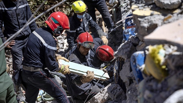 Lực lượng cứu hộ tìm kiếm trong đống đổ nát sau động đất ở Morocco - Ảnh: AFP