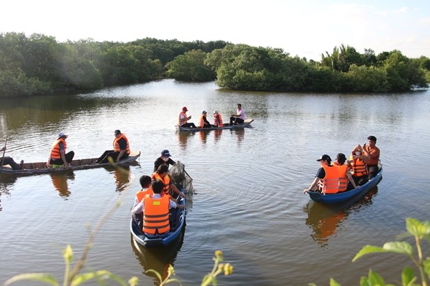 Members of the Thai delegation experience a boat tour of a mangrove forest in Ba Tri district, Ben Tre province.