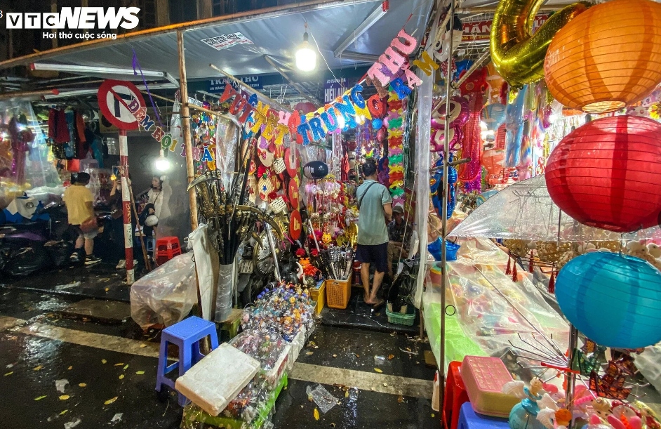 Tiểu thương Hàng Mã vội vã bê đồ, chạy trốn cơn mưa lớn.