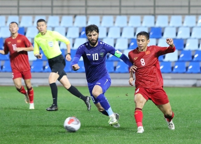 Do Hung Dung (8) and teammates had no answers against a meticulous Uzbekistan side. (Photo: VFF)