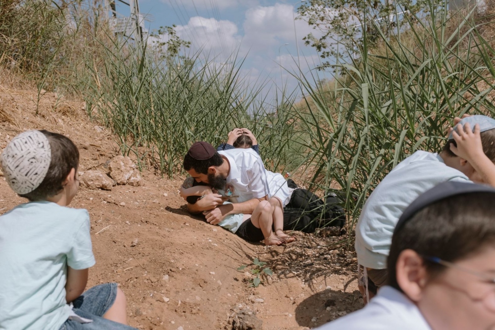 Người dân Israel ẩn nấp sau khi nghe thấy tiếng còi cảnh báo về tên lửa bắn tới từ Gaza ở Rehovot, Israel, vào ngày 13/10.
