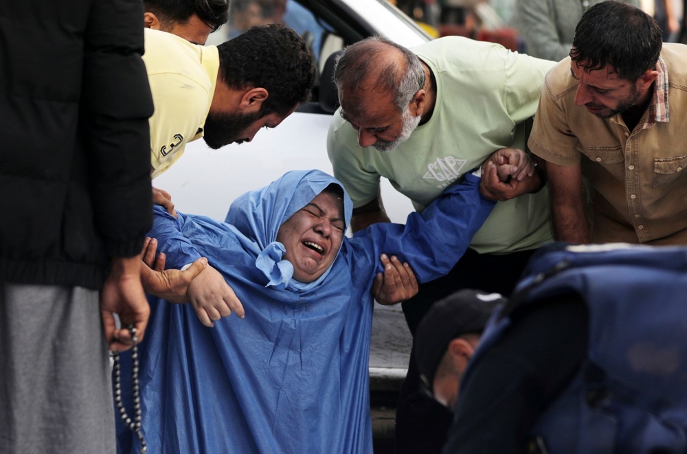 Một phụ nữ Palestine khóc ngất sau khi nhận được tin người thân đã thiệt mạng sau vụ tấn công của Israel.