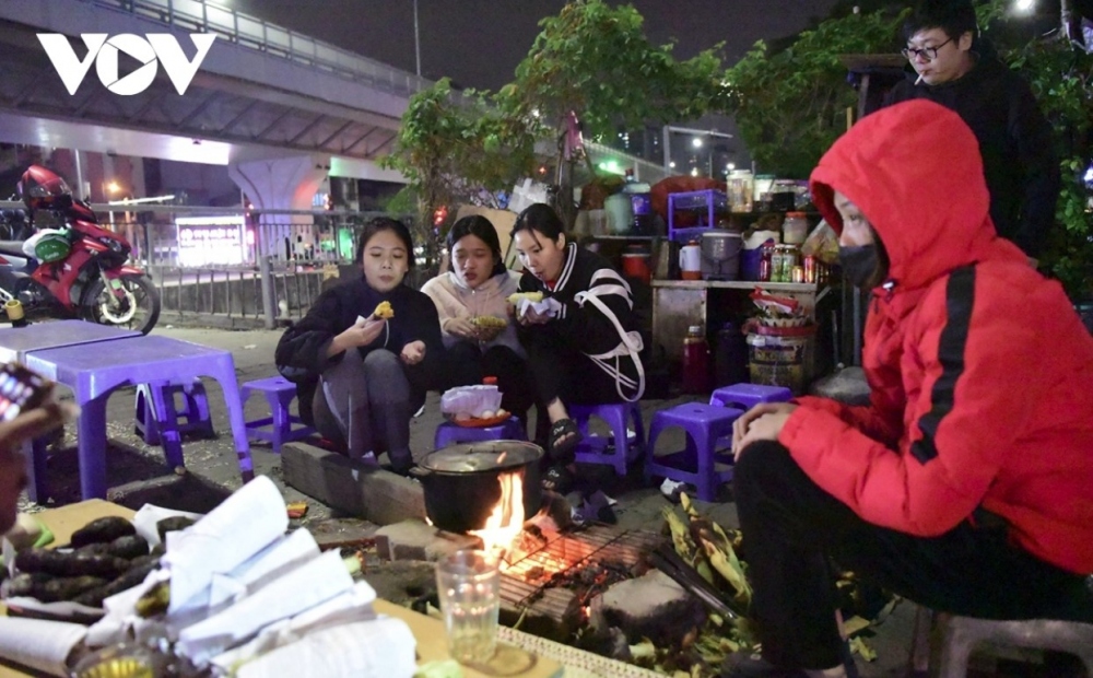 With the temperature dropping at night, street vendors try to sell grilled corn and potatoes in the hope of making more money before heading home.