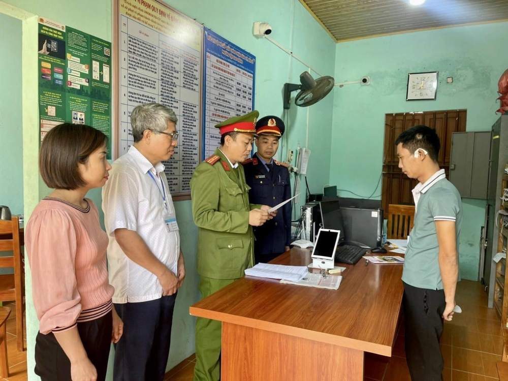 Cảnh sát đọc các quyết định tố tụng với Tuấn. (Ảnh: Công an cung cấp)