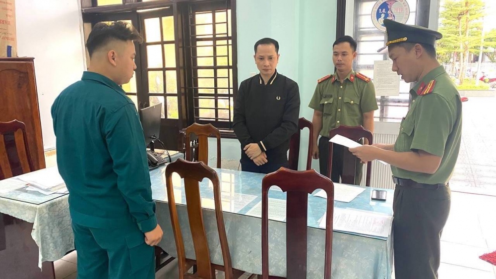 Cơ quan điều tra thực hiện lệnh bắt bị can để tạm giam Nguyễn Quang Tứ (áo đen).