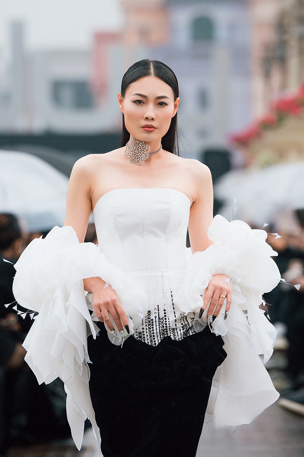Dàn người mẫu catwalk trong mưa phùn trên nền nhạc giao hưởng do nhạc trưởng Lưu Quang Minh chỉ huy cùng dàn nhạc Maius Philharmonic.