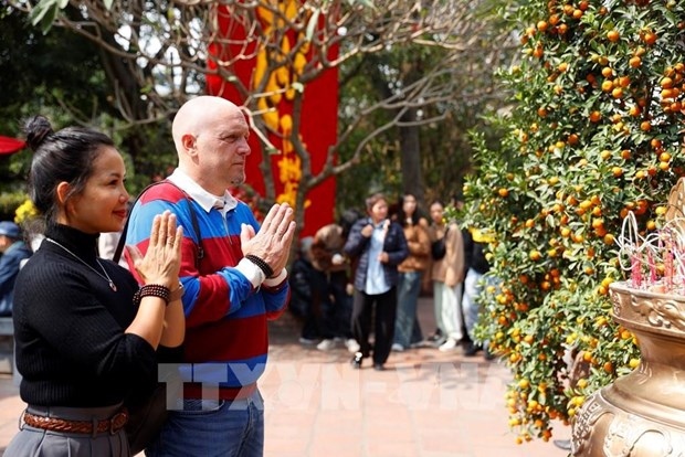 Tourists visit Ngoc Son temple at Hoan Kiem lake, Hanoi.