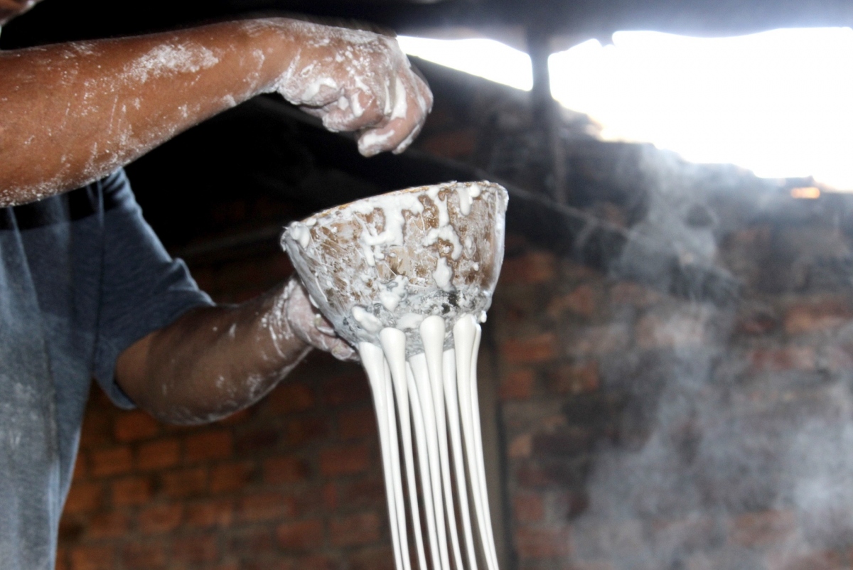 They then take the mixture and put it in a large copper bowl which has many small holes in the bottom whilst letting the flour flow into a boiling saucepan.