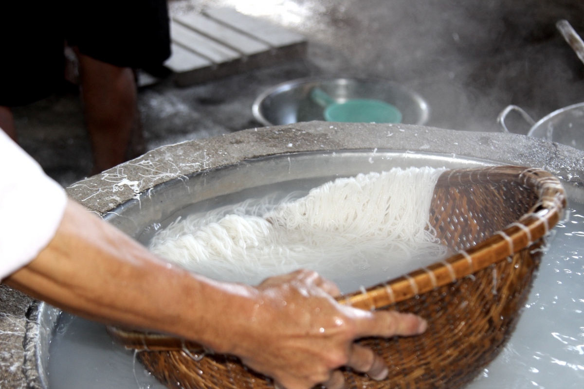 The makers take the strings out and let it cool off before forming them into small squares on a big wooden sheet.