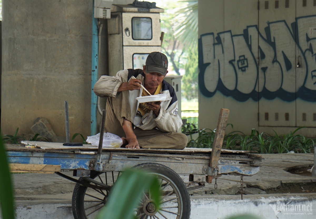 A worker seeks the shade as he tries to avoid the harsh sun.