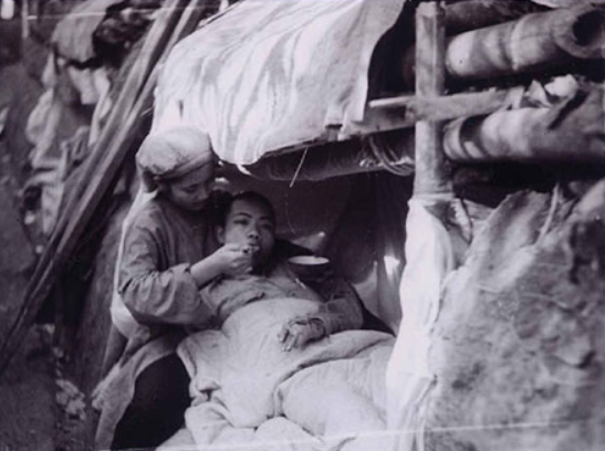 Nữ y tá tận tình bón từng thìa cháo cho thương binh ngoài hỏa tuyến (Ảnh tư liệu)