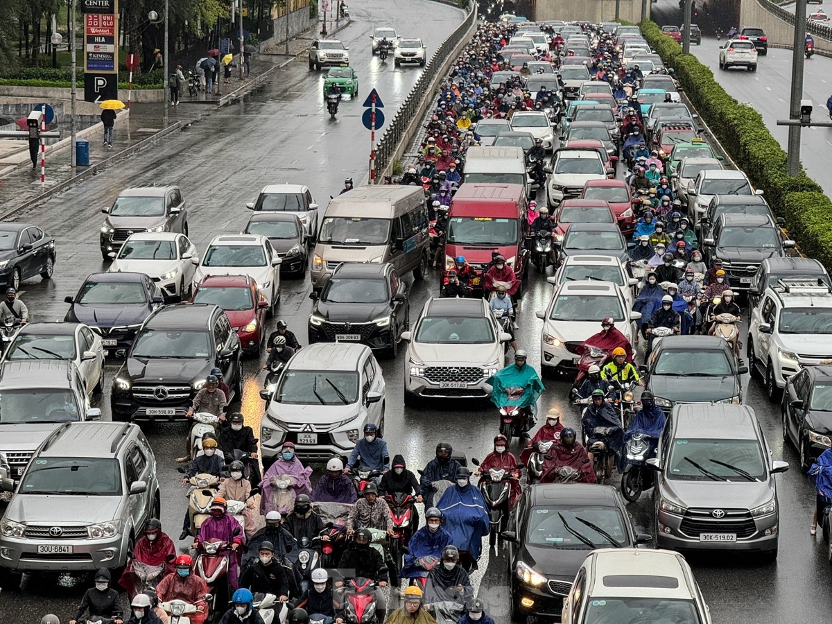 A queue of vehicles is left at a standstill amid the cold weather and rain.