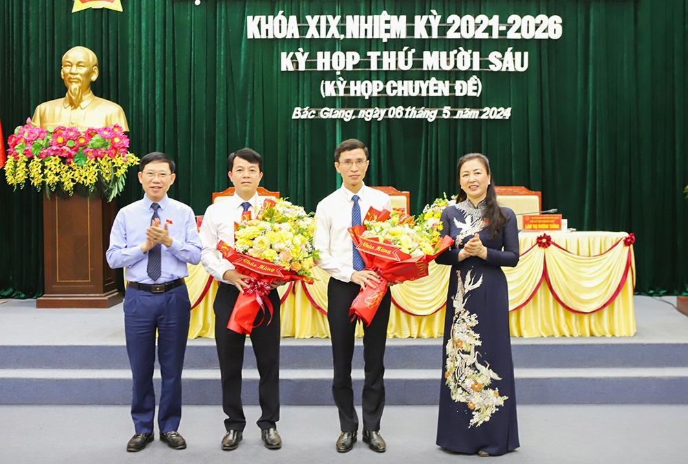 Bà Lê Thị Thu Hồng - Chủ tịch HĐND tỉnh Bắc Giang; ông Lê Ánh Dương - Chủ tịch UBND tỉnh Bắc Giang tặng hoa chúc mừng các tân Ủy viên UBND tỉnh