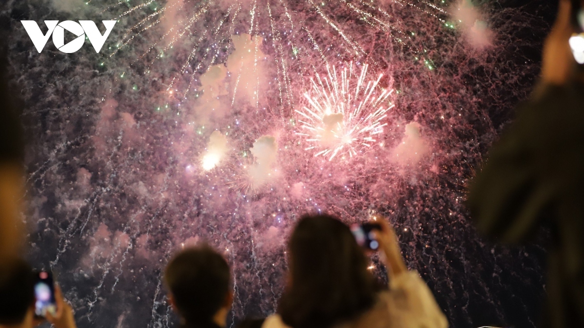 Thousands of people cheer and show excitement.