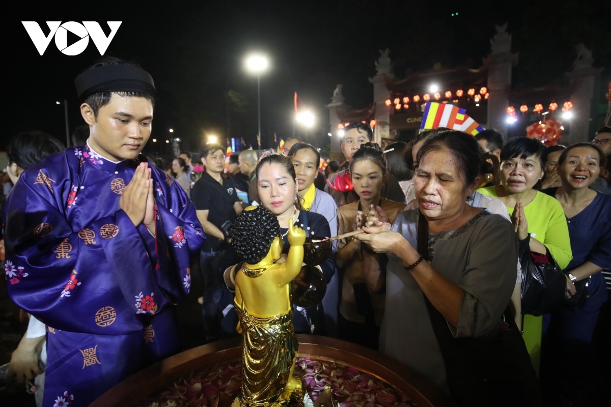 Followers give a Buddha's statue a shower, a ritual believed to show one's respect for Buddha and to help cleanse their soul.