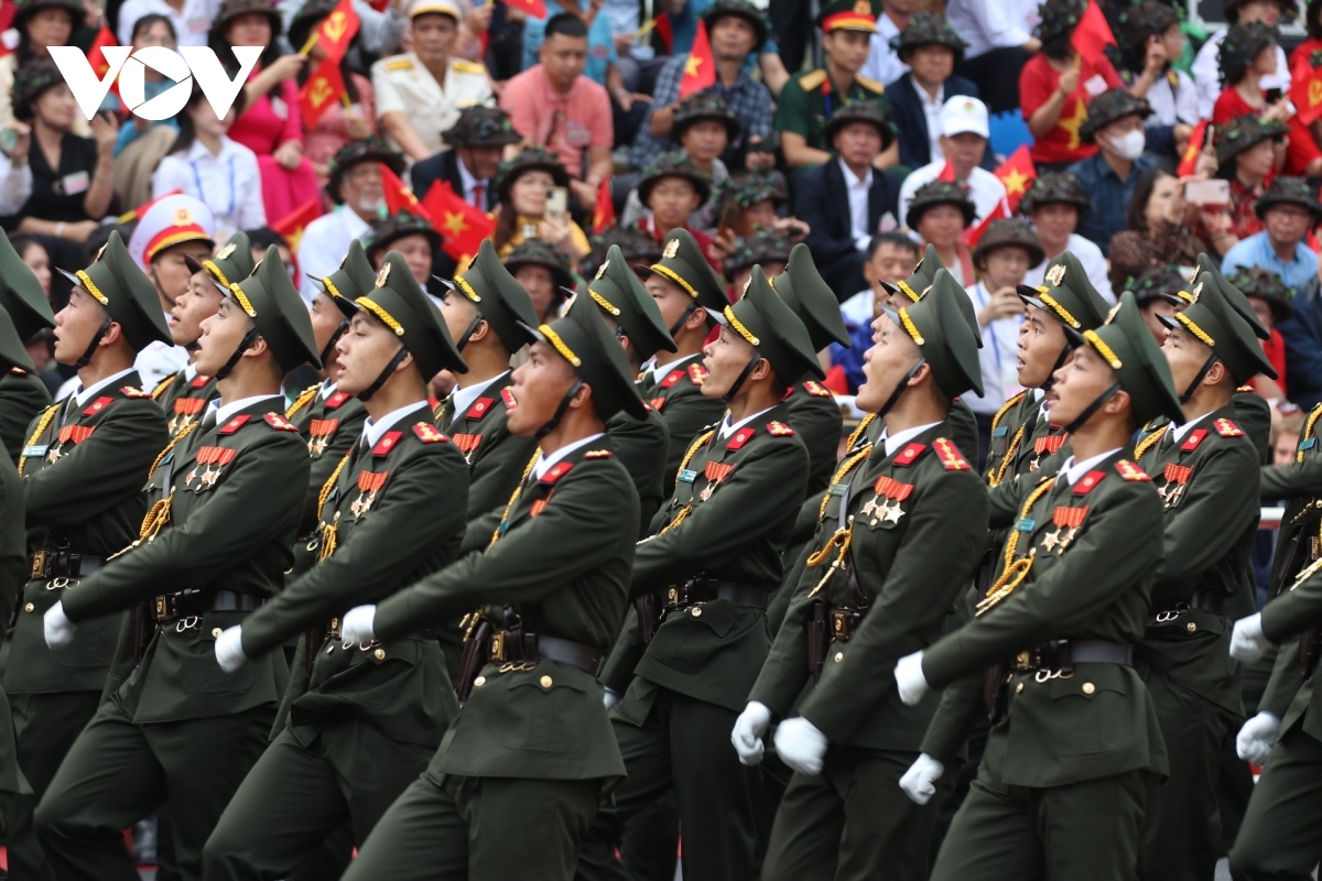 The military parade features various armed forces and militia members, along with combatants, officers, and peacekeepers.