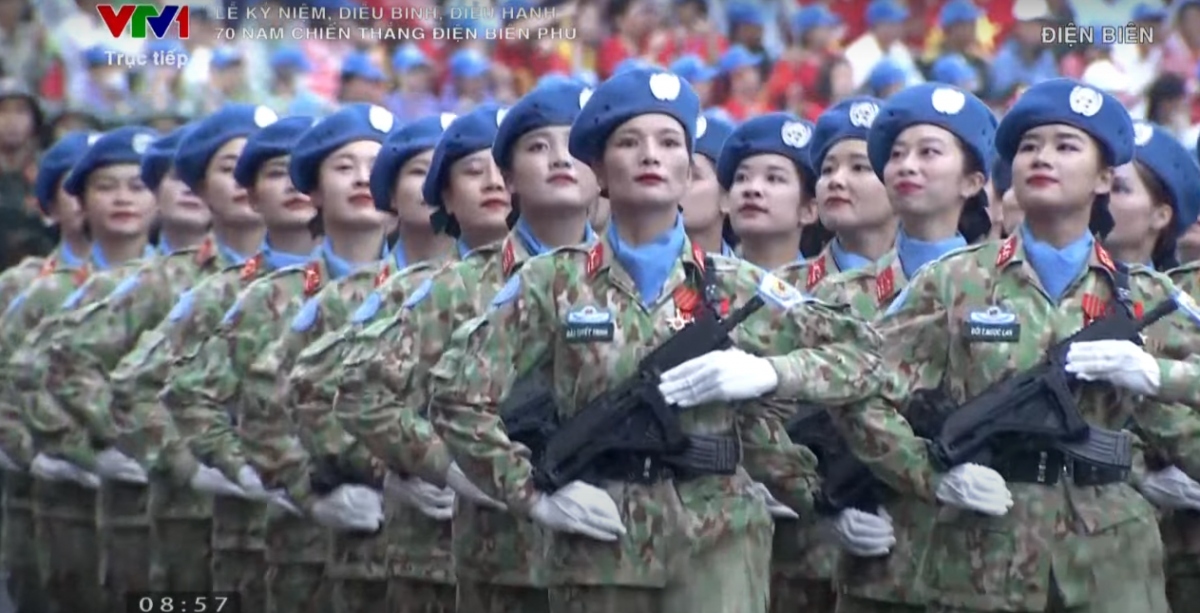 The military parade involves armed forces and militia members, along with combatants, officers, and peacekeepers.