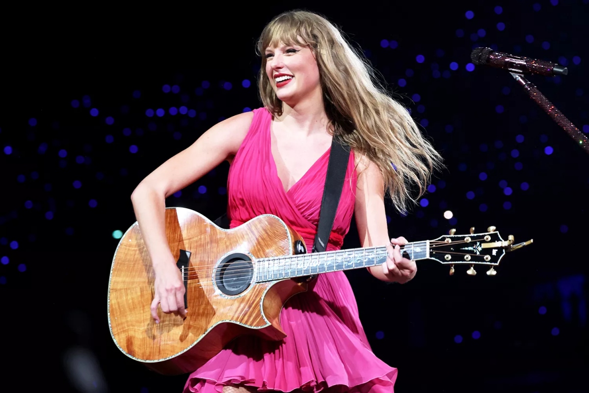 Khi trình diễn những ca khúc acoustic, Taylor Swift yêu kiều hơn trong chiếc váy màu hồng. Bộ trang phục này có nét tương đồng với những bộ váy suông mà cô hay lựa chọn trong khoảng thời gian mới ra mắt.