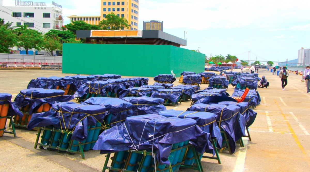 Fireworks barrages are covered with large nylon sheets to protect tubes from sudden rain.