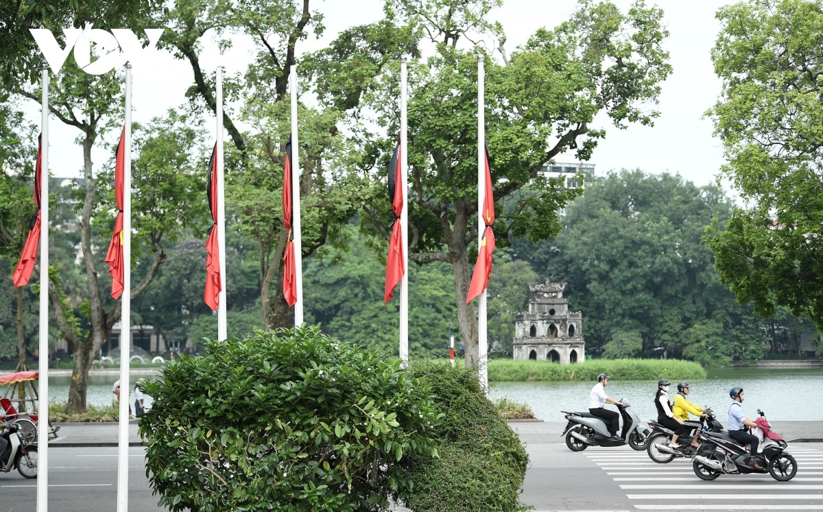 Flags are at half-mast on Dinh Tien Hoang street in front of the Turtle Tower in the heart of Hanoi.
