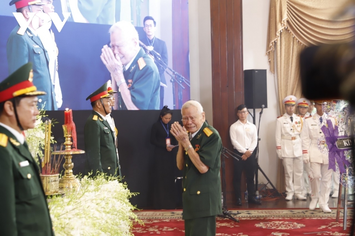 An old war veteran bursts into tears standing in front of the Party leader’s memorial photo.