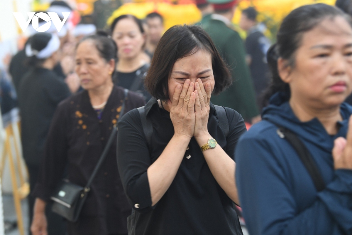 They look somber during the emotional service, believing that Vietnam has just lost a respected and competent leader,