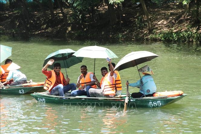 Indian tourists take a boat tour to explore Trang An Landscape Complex