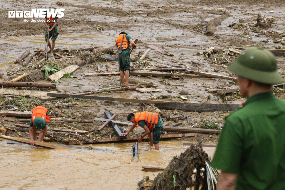 Under the scorching heat of 32-34 degrees Celsius, soldiers and local militia tirelessly wade through mud with sticks and hoes searching for the dead bodies.