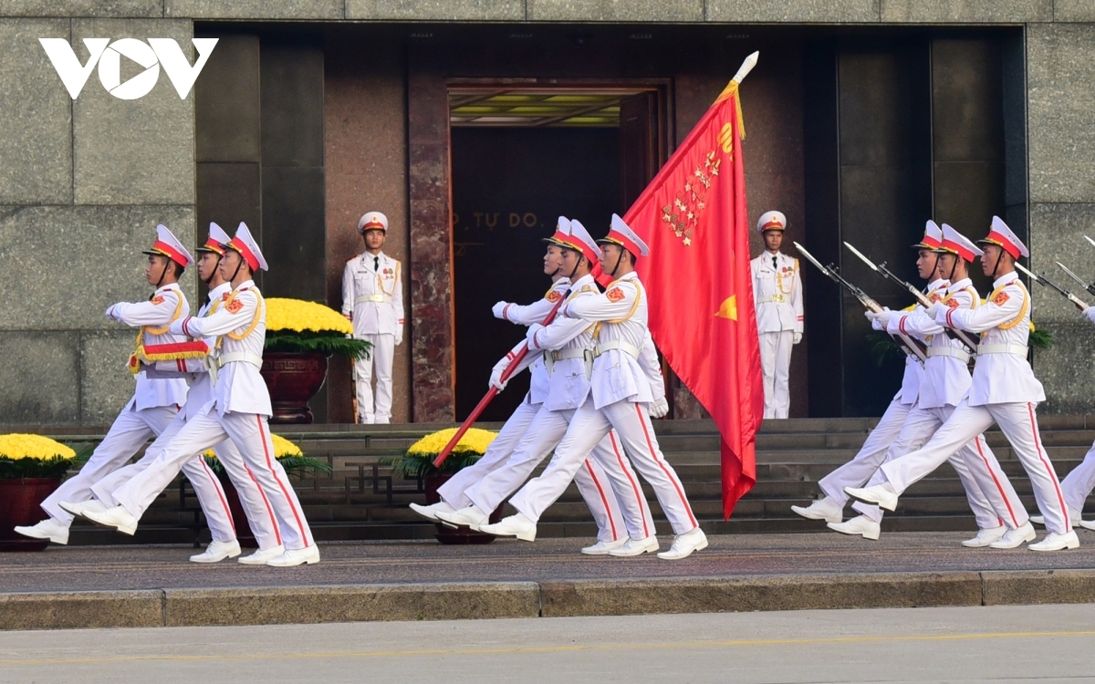 Following the completion of the flag raising ritual, the guards march in front of the Ho Chi Minh Mausoleum back to their posts, signaling the end of the ceremony.