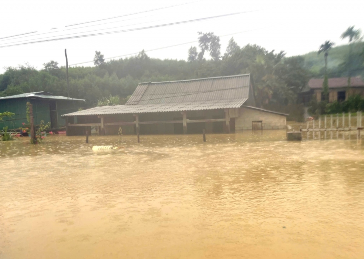 Some houses are left fully under water, except for their roofs.