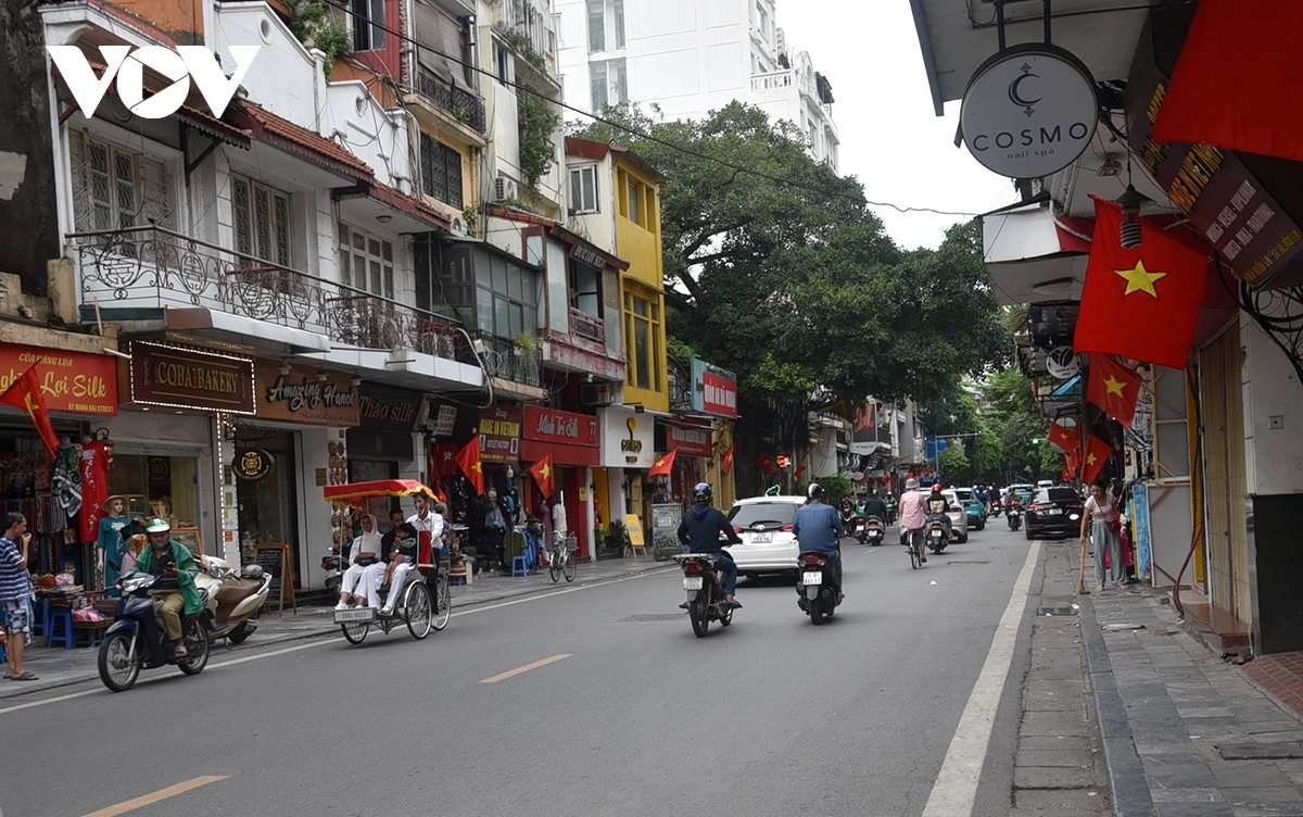 Hang Gai street transforms into a canvas of red and yellow as the national flag waves proudly.