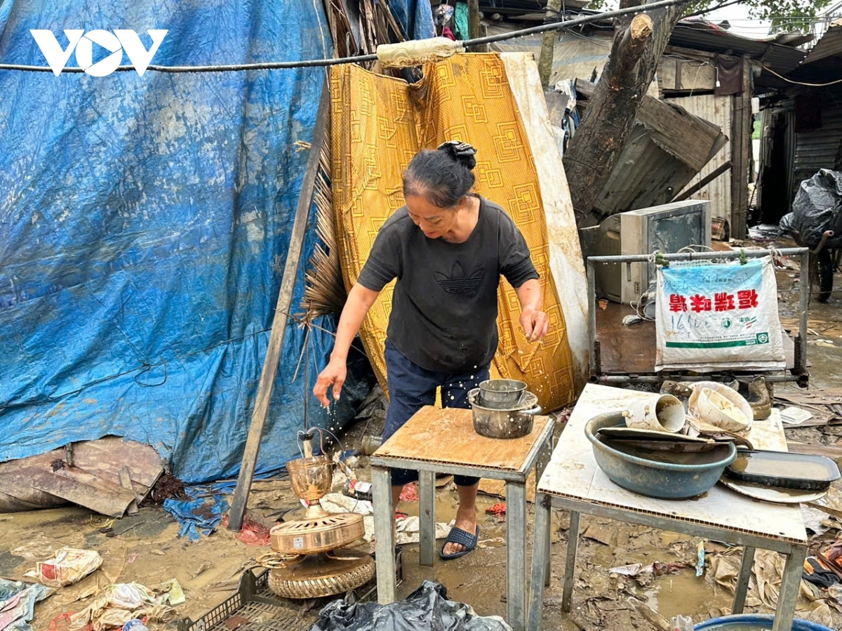 She searches for reusable items in piles of trash and mud.
