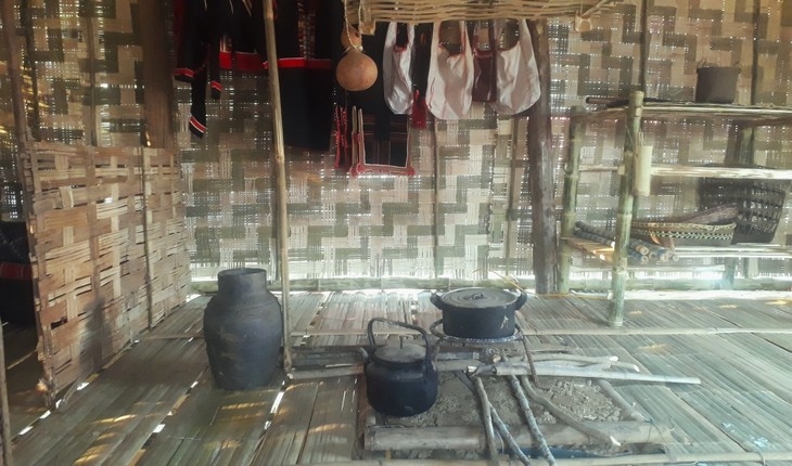 A woodstove in the main room in the Kho Mu's house