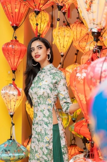She poses for a photo in Hoi An city whilst donning an Ao Dai (traditional long dress).