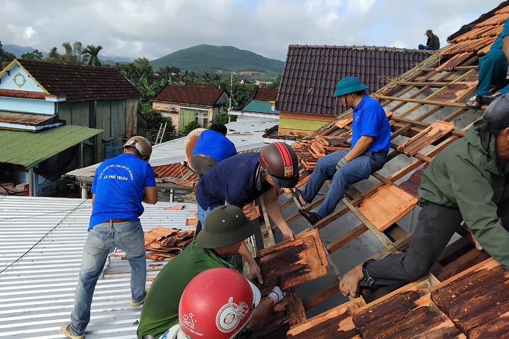 Các lực lượng thanh niên, công an, dân quân giúp dân lợp lại mái nhà