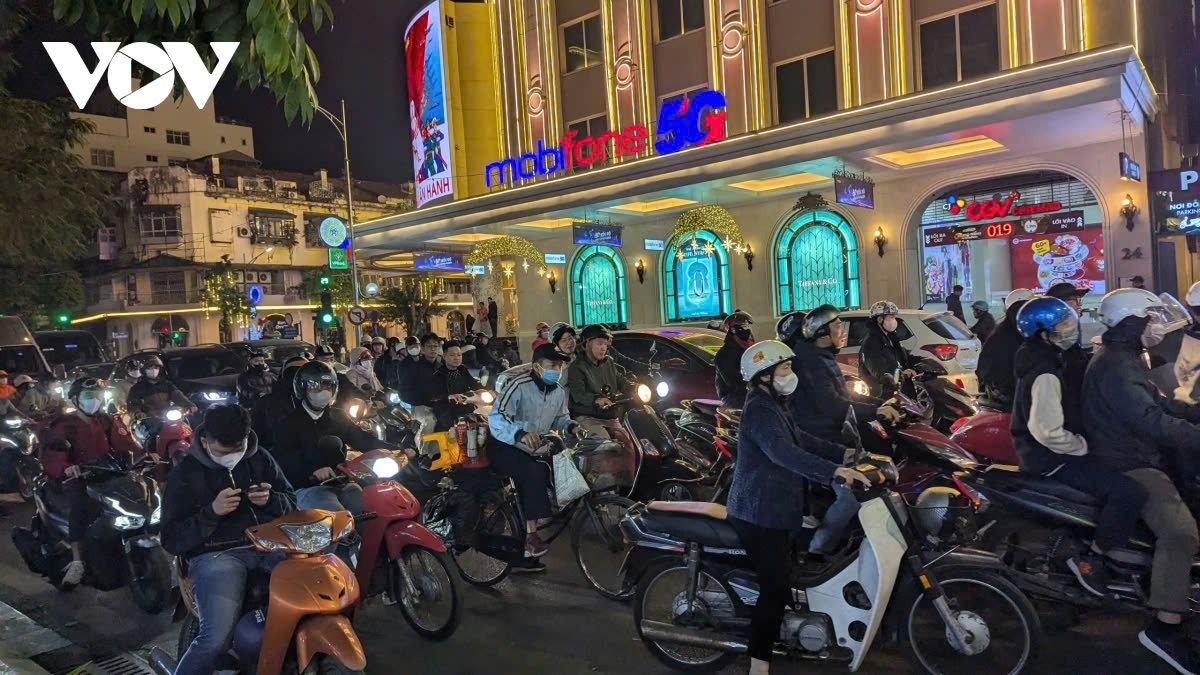 In Hanoi, major streets leading to the city center are packed with hordes of people, causing congestion, with vehicles jostling for space and inching forward little by little.