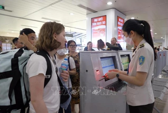 Security personnel checks passengers' information at Noi Bai International Airport