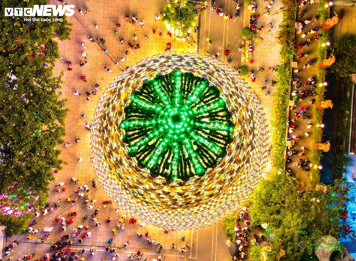 From high above, the top of the Christmas tree glows with shimmering and magical colours.