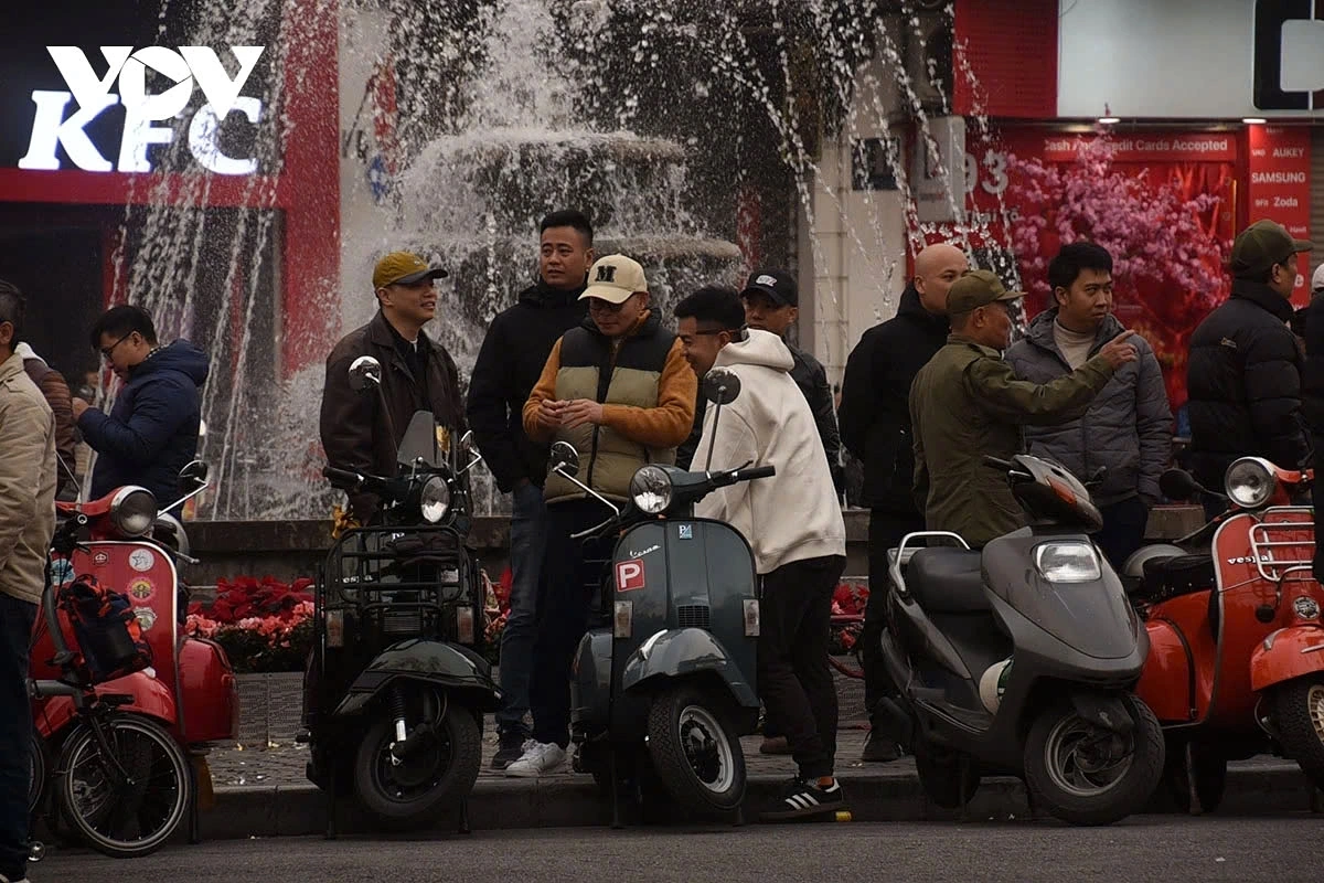 Various types of motorcycles, classic Vespas, and vintage bicycles are gathered for displays.
