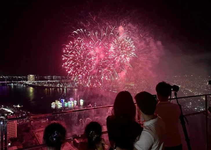 Tourists watch a fireworks display in Da Nang city