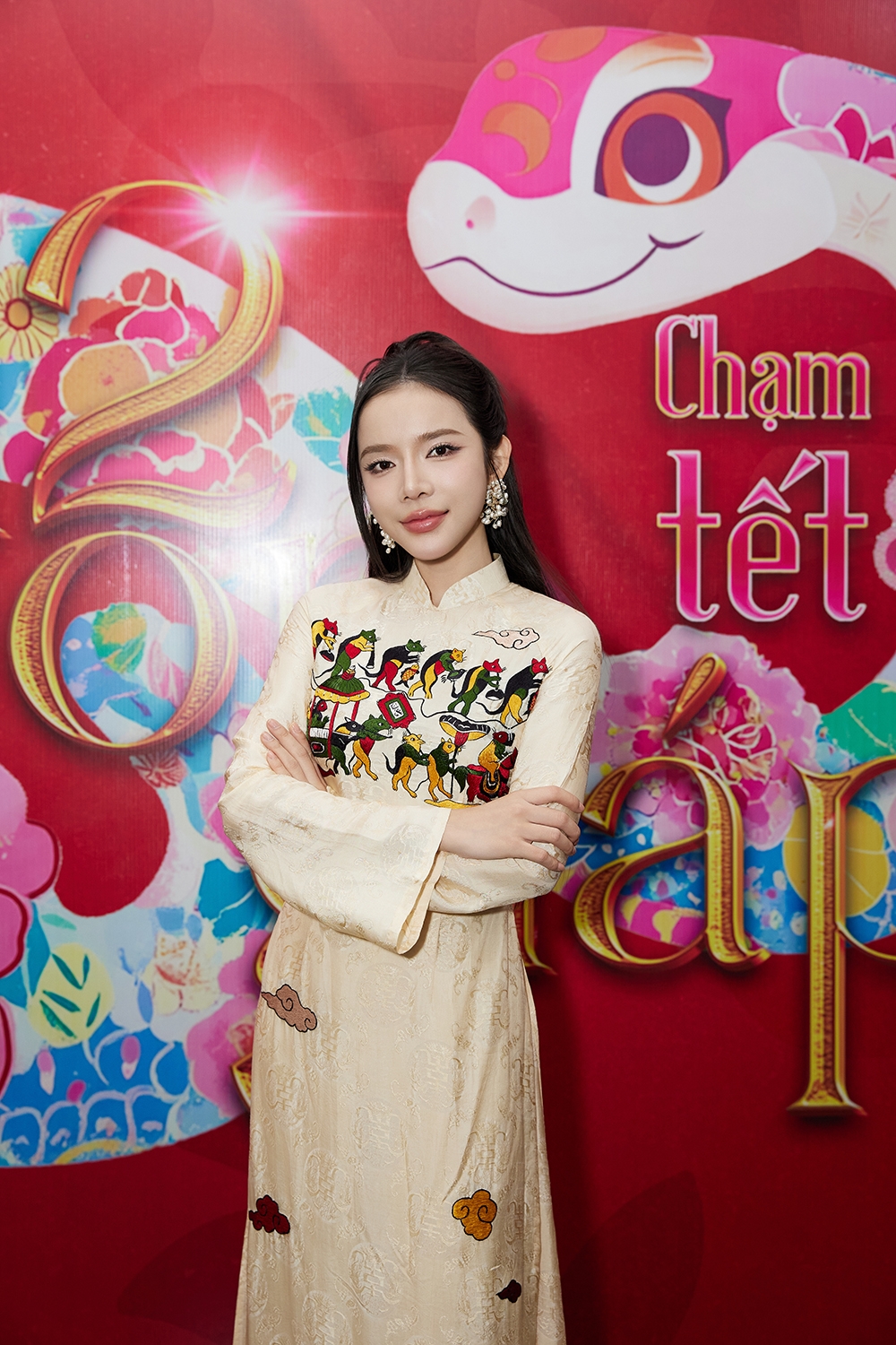Ly Ly duyên dáng trong trang phục áo dài với bức “Đám cưới chuột” trong tranh dân gian đông hồ, nhưng được sáng tạo bố cục và kết hợp cùng vân mây ngũ sắc - một hoạ tiết cổ truyền của Việt Nam, thể hiện ý nghĩa về những điềm lành, bình an, may mắn!