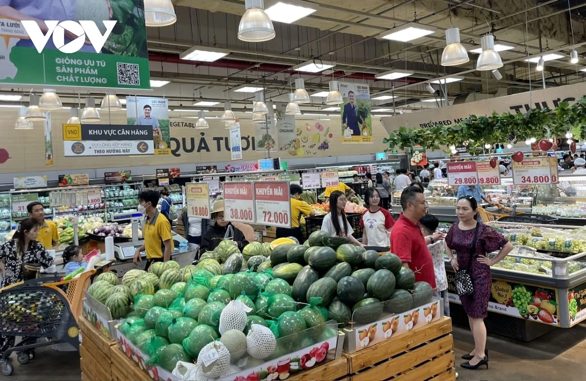 Fresh vegetables and fruits are displayed in abundance at the supermarket.