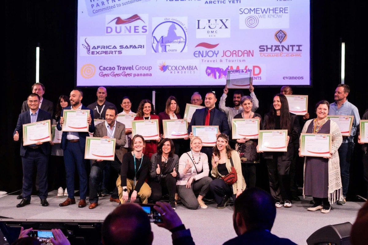 Lux Travel DMC representatives showcase their Travelife Certified Sustainability Award 2025 certificates
