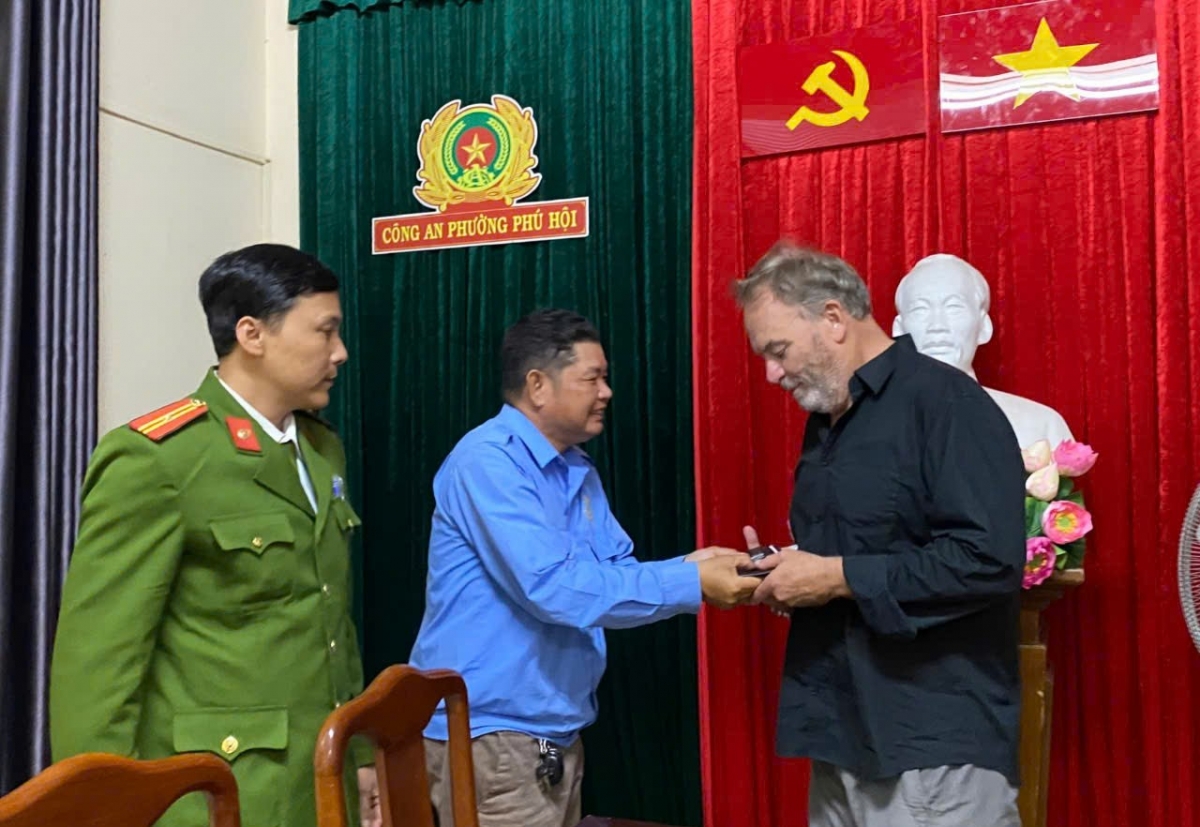 Ông Giáp Phương Hùng và Công an phường Phú Hội trao trả tài sản lại cho ông O’Graday Lawrence